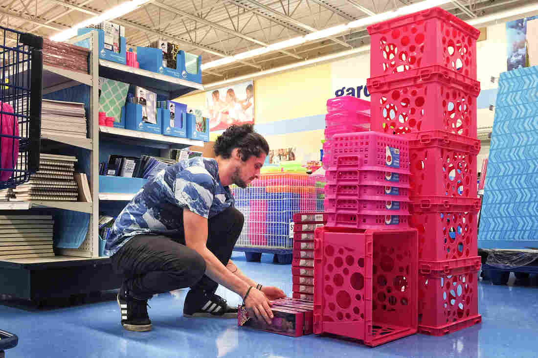 Carson Brown, a 30-year-old photographer, constructs a sculpture at Meijer, a large retailer in Michigan.