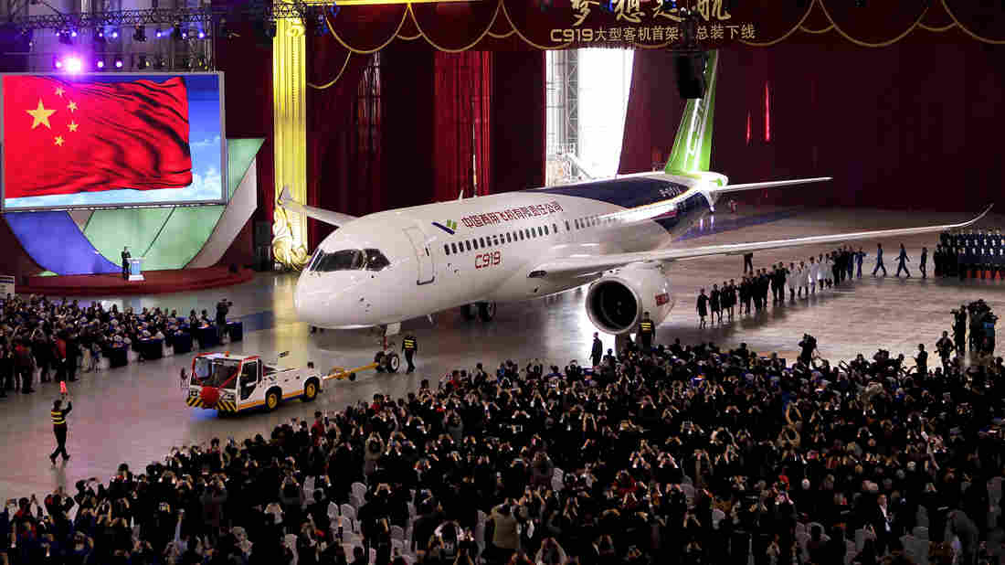 The first twin-engine C919 passenger plane made by the Commercial Aircraft Corporation of China is pulled out of the company's hangar Monday during a ceremony near Shanghai.