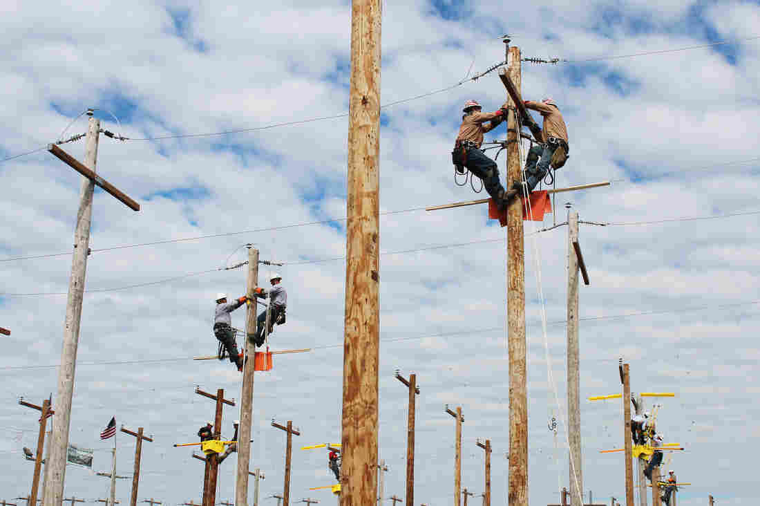 Lineman rodeo contestants participate in an event that simulates an electrical problem to be fixed in Bonner Springs, Kan. The challenge was announced the night before.