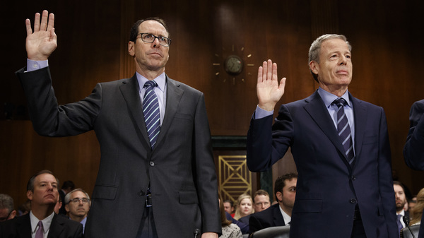 AT&T CEO Randall Stephenson (left) and Time Warner CEO Jeff Bewkes are sworn in Wednesday before testifying at a Senate committee hearing on the proposed merger of their companies.