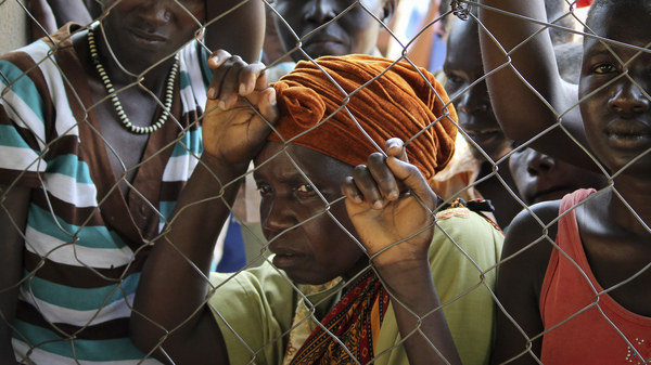 In this photo taken Monday, Nov. 14, 2016, women stand outside a U.N. Refugee Agency site in Yei, in southern South Sudan. The formerly peaceful town of Yei is now a center of the renewed civil war.